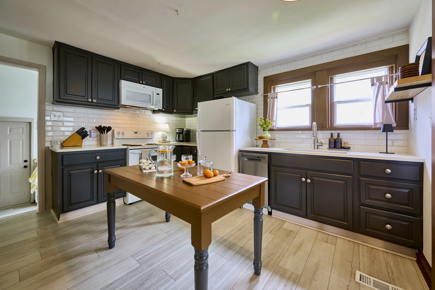 Fully equipped kitchen at The Lakeside at Sylvan — dark navy cabinets, wood island, subway tile backsplash